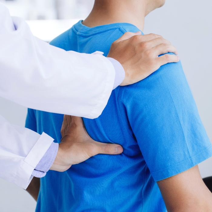 chiropractor-adjusting-man-shoulder-fulton-county-pa