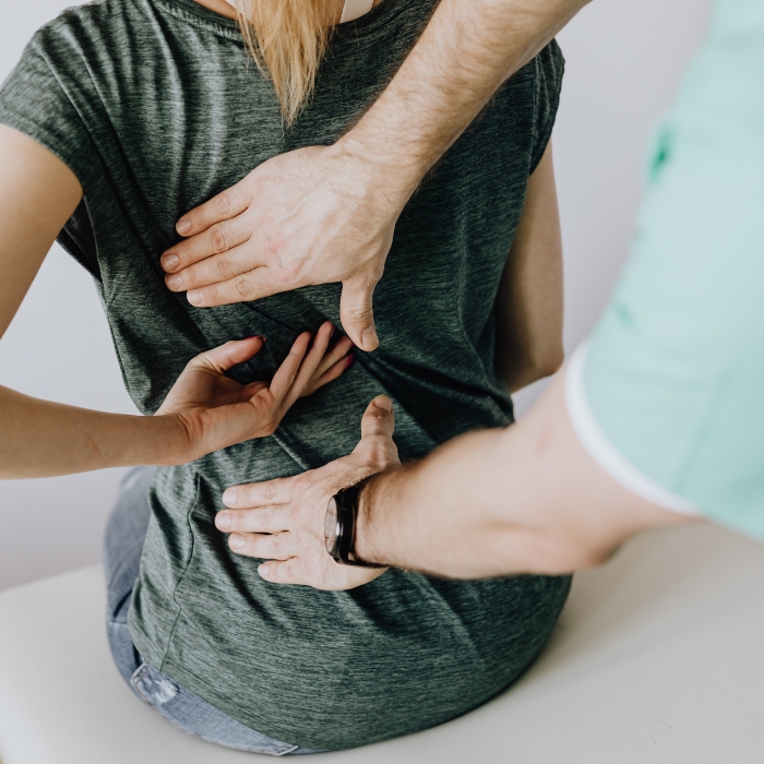 chiropractor-adjusting-woman-back-at-clinic-adams-county-pa